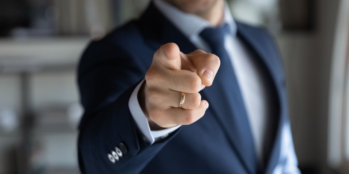 Businessman pointing finger at you