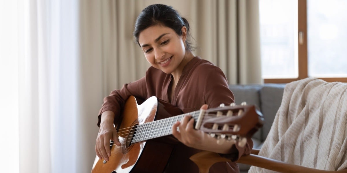 Woman learning to play the guitar