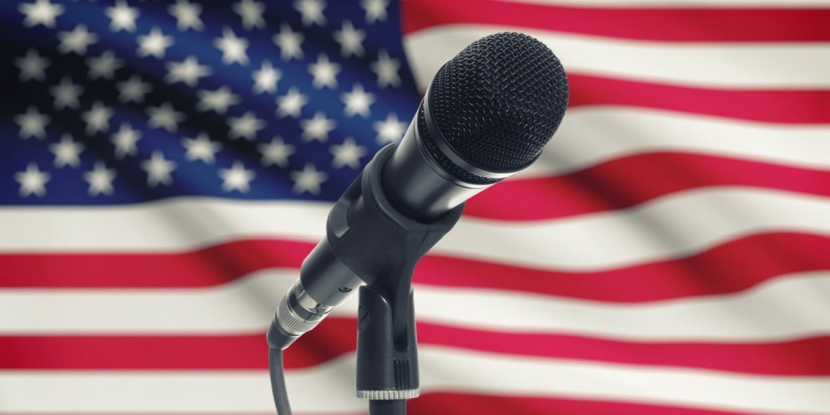American flag with microphone in front of it